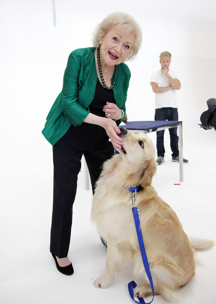 Betty White petting a dog
