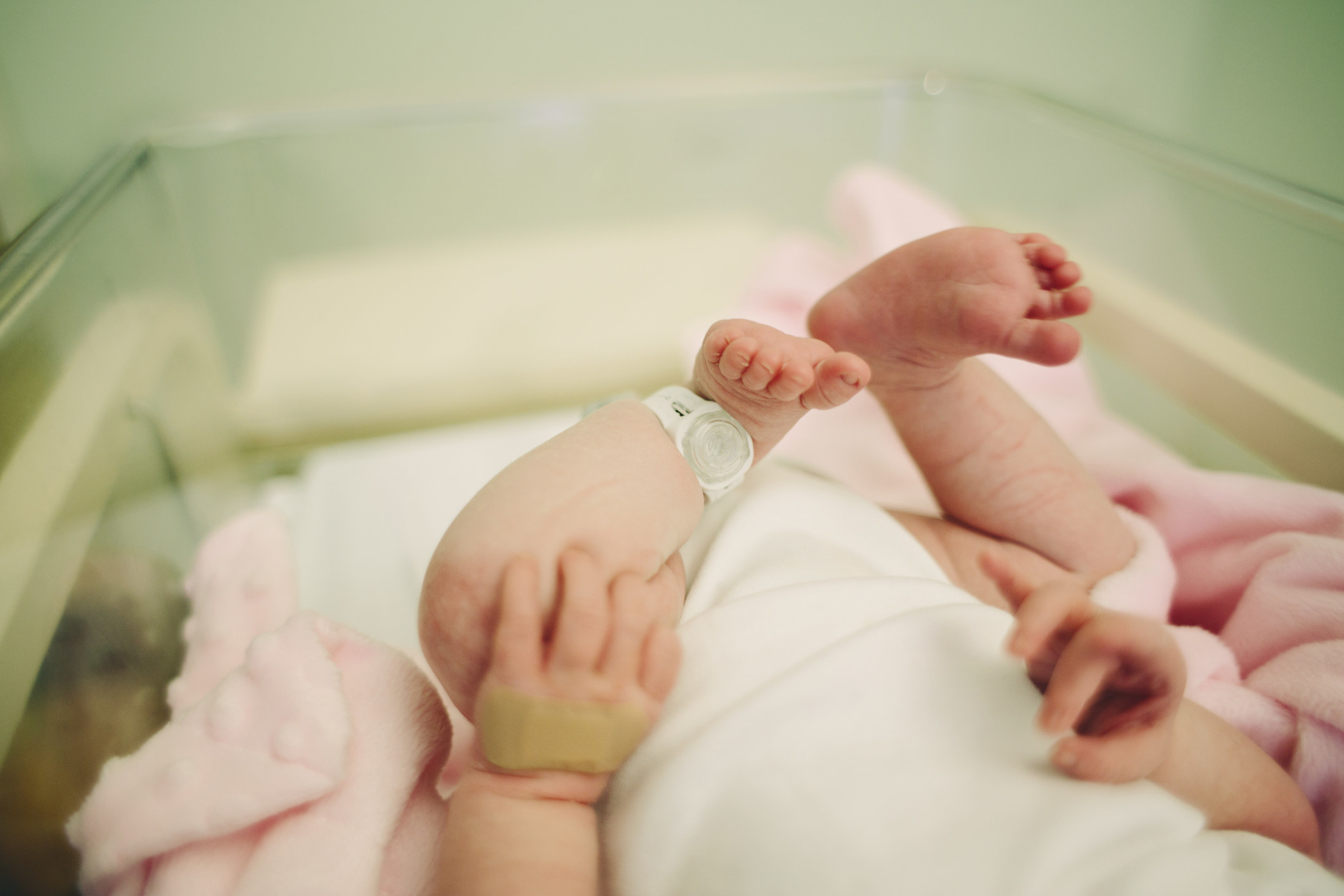 a newborn baby in a hospital crib
