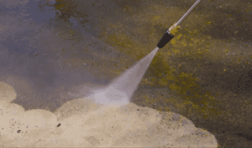 a gif of the pressure washer being used on dirty pavement