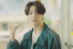Jungkook from BTS holding a donut in the Dynamite music video