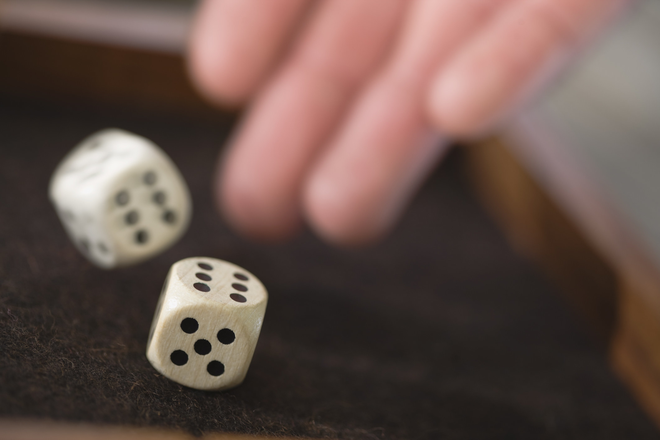 a person&#x27;s hands throwing dice