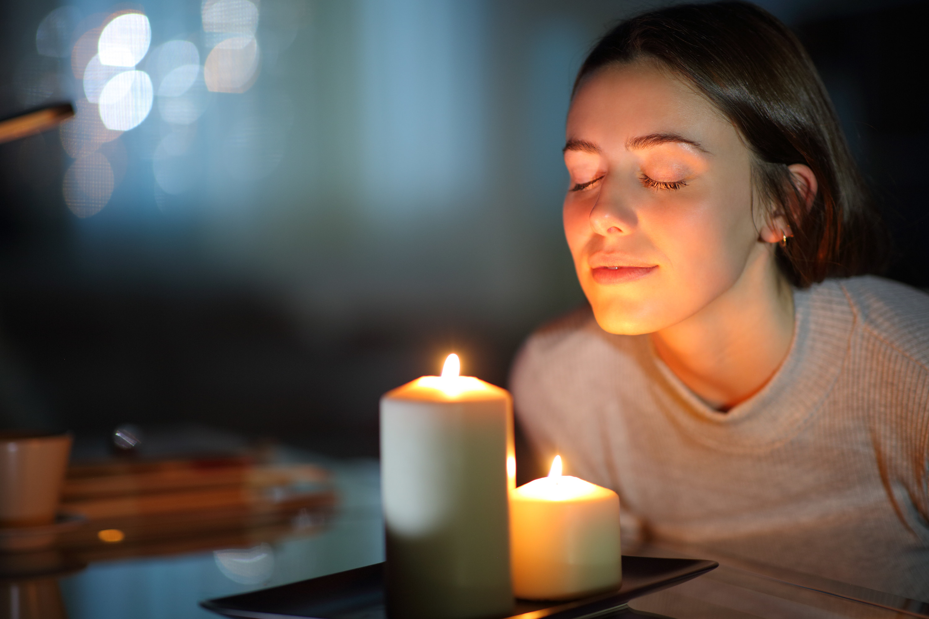 A woman smelling a candle