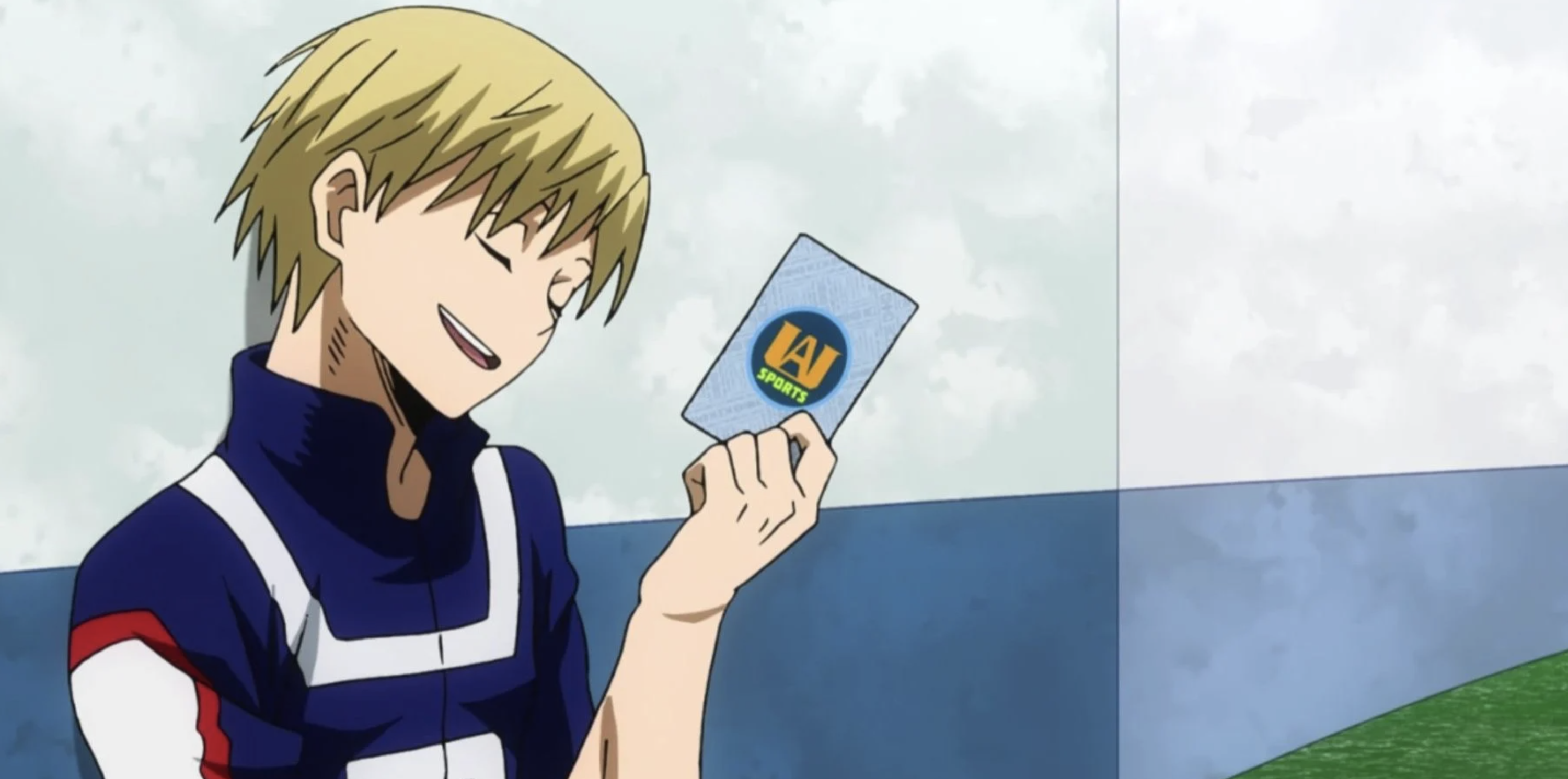 Neito Monoma from My Hero Academia leaning against a wall and holding up a card