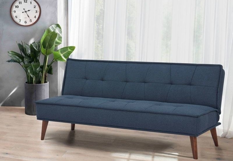 a navy blue futon bed in a living room
