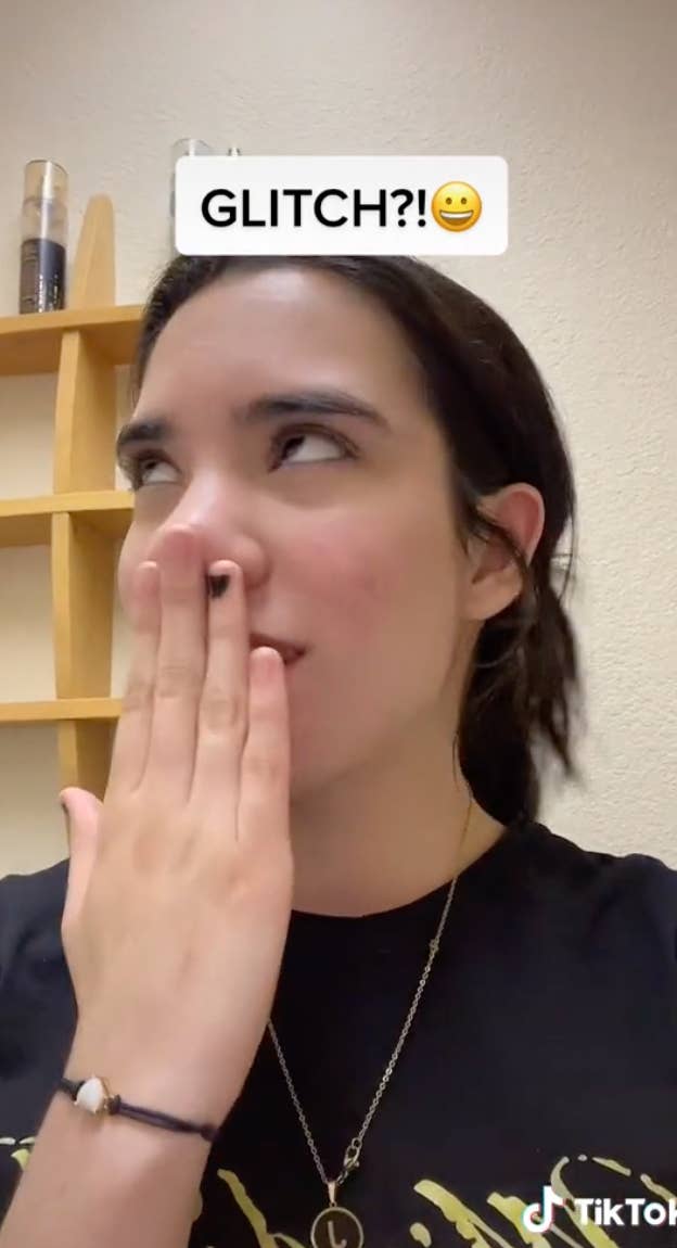 Woman covering mouth with text "Glitch?!"