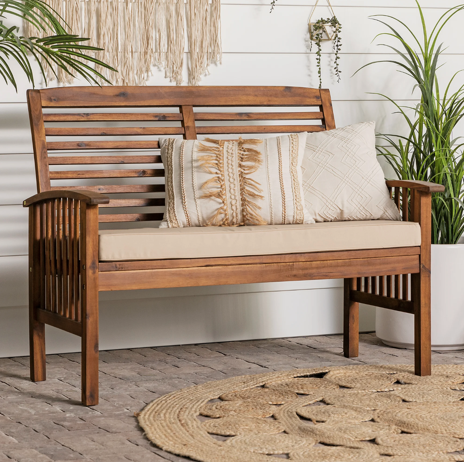 The bench outdoors with cushions on it