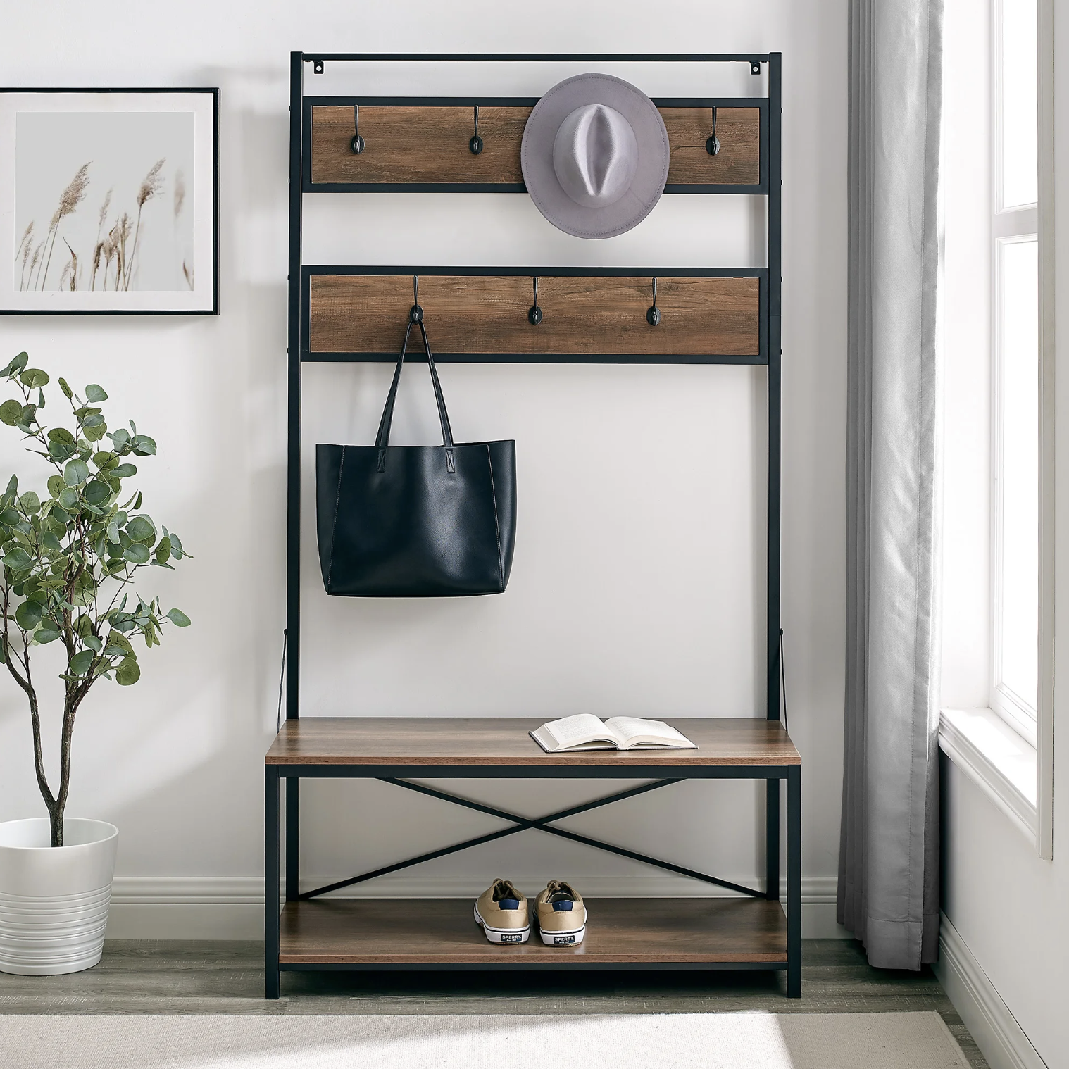 The organizer in an entryway with a book, shoes, a hat, and a bag on it