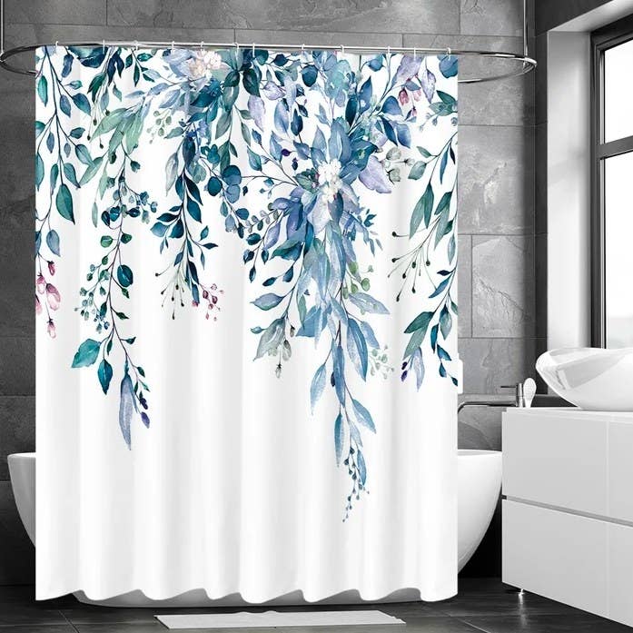 Shower curtain hanging in front of a free standing tub