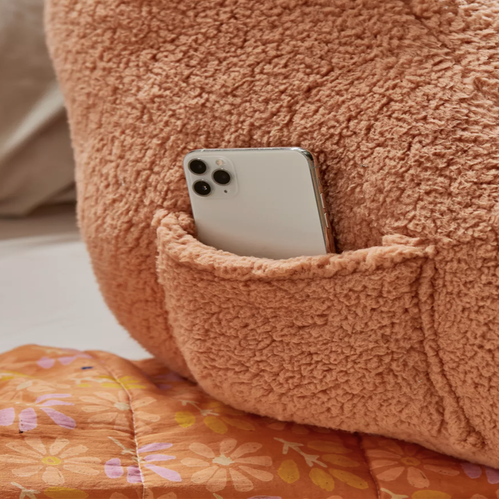 A phone in the pocket of the pillow