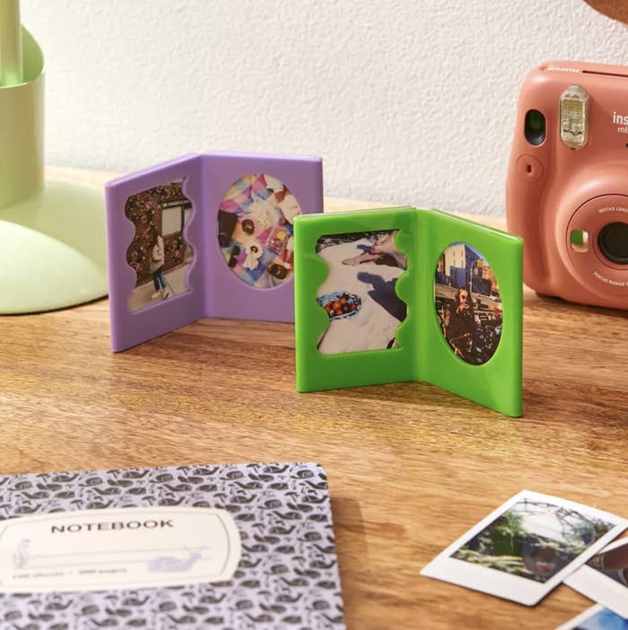 The two picture frames with photos in them on a desk