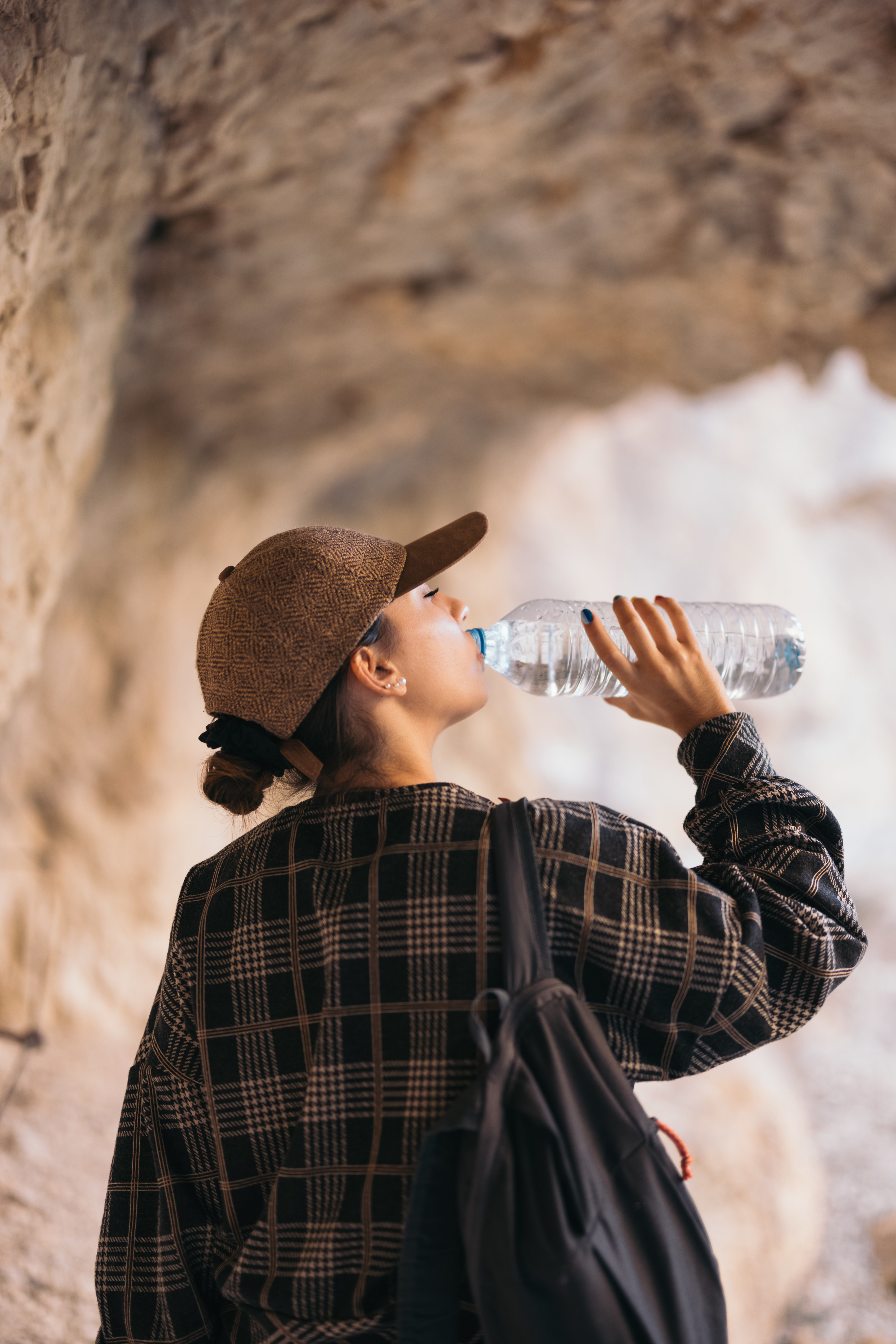 A woman drinking water on a hike
