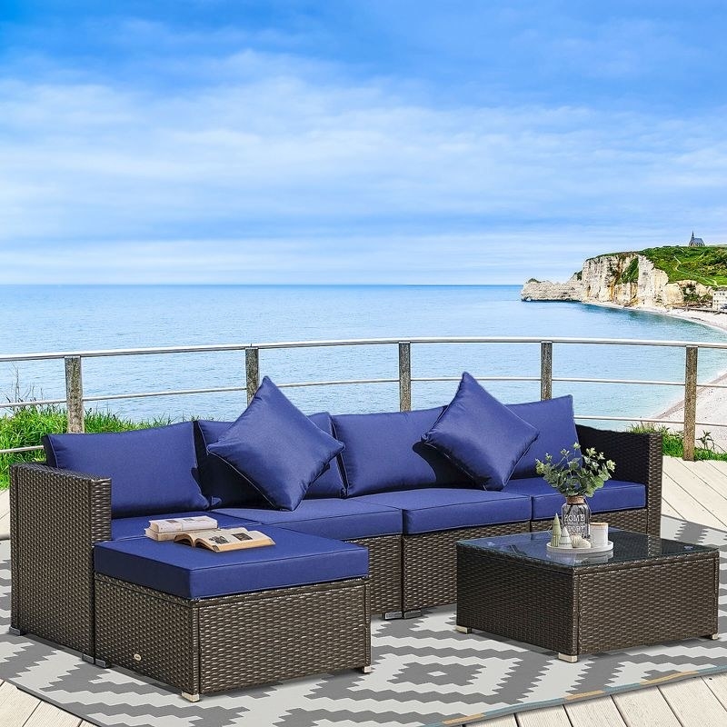 A navy blue six-piece rattan sofa set overlooking the coast