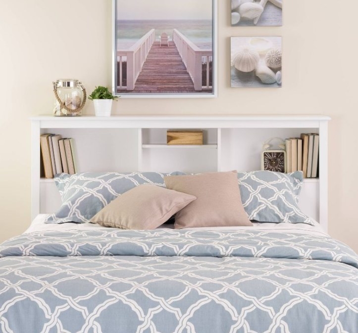 White bookcase headboard behind bed