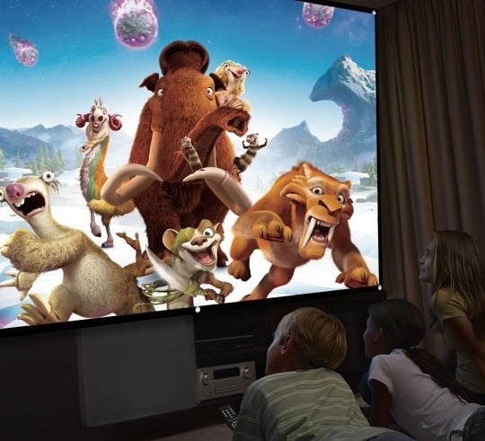 kids watching a movie with projector