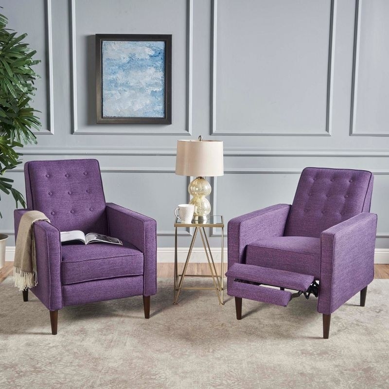 a set of purple recliner chairs in a living room