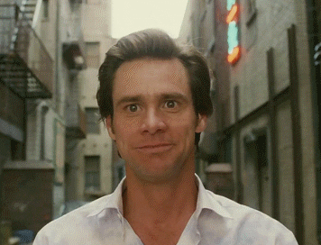 GIF of Jim Carrey giddily smiling in the movie &quot;Bruce Almighty&quot;