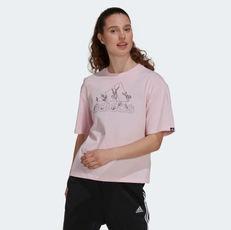 a model wearing a pink floral logo tee