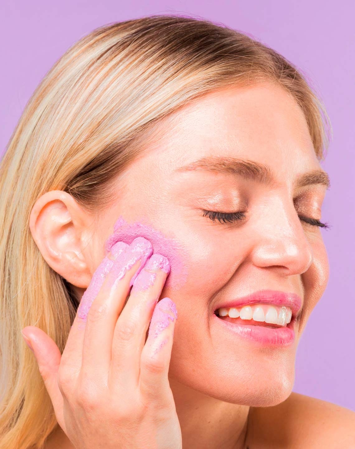 Model using pink product on face