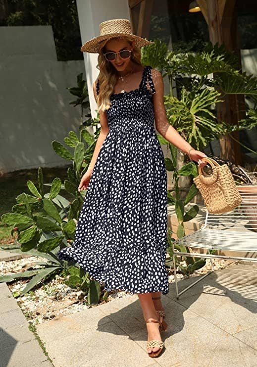Model is wearing the navy dotted maxi dress