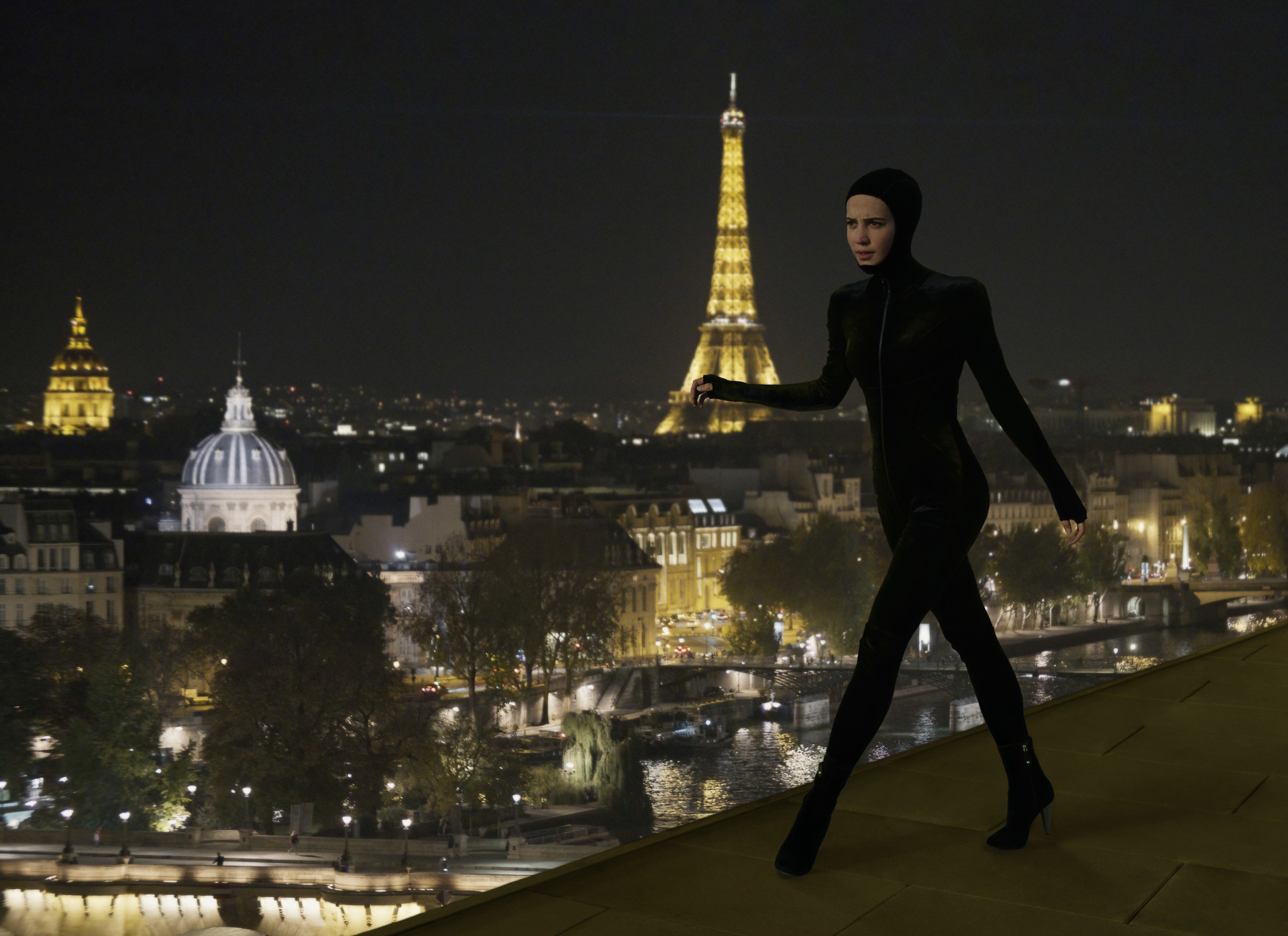 Mira wearing her catsuit costume against the Paris skyline in Irma Vep