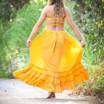 Reviewer in the mustard colored dress showing the backless straps