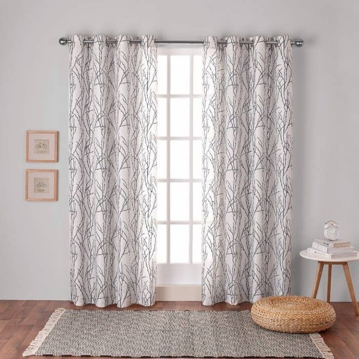 Curtains with a branches design hanging from window in home