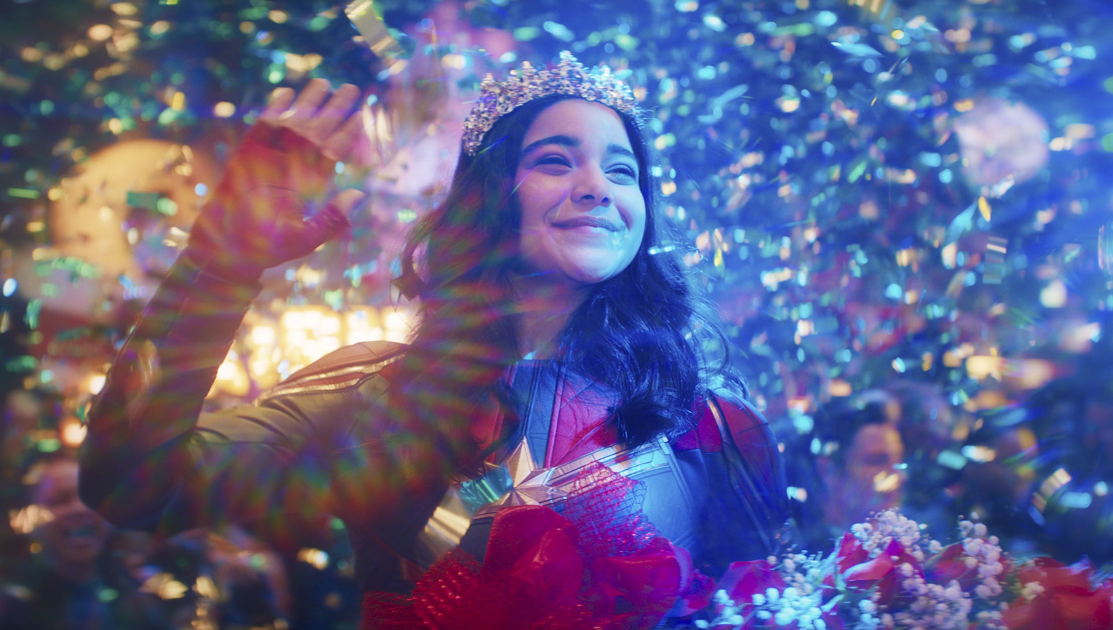 Iman Vellani dressed as Ms. Marvel wearing a crown