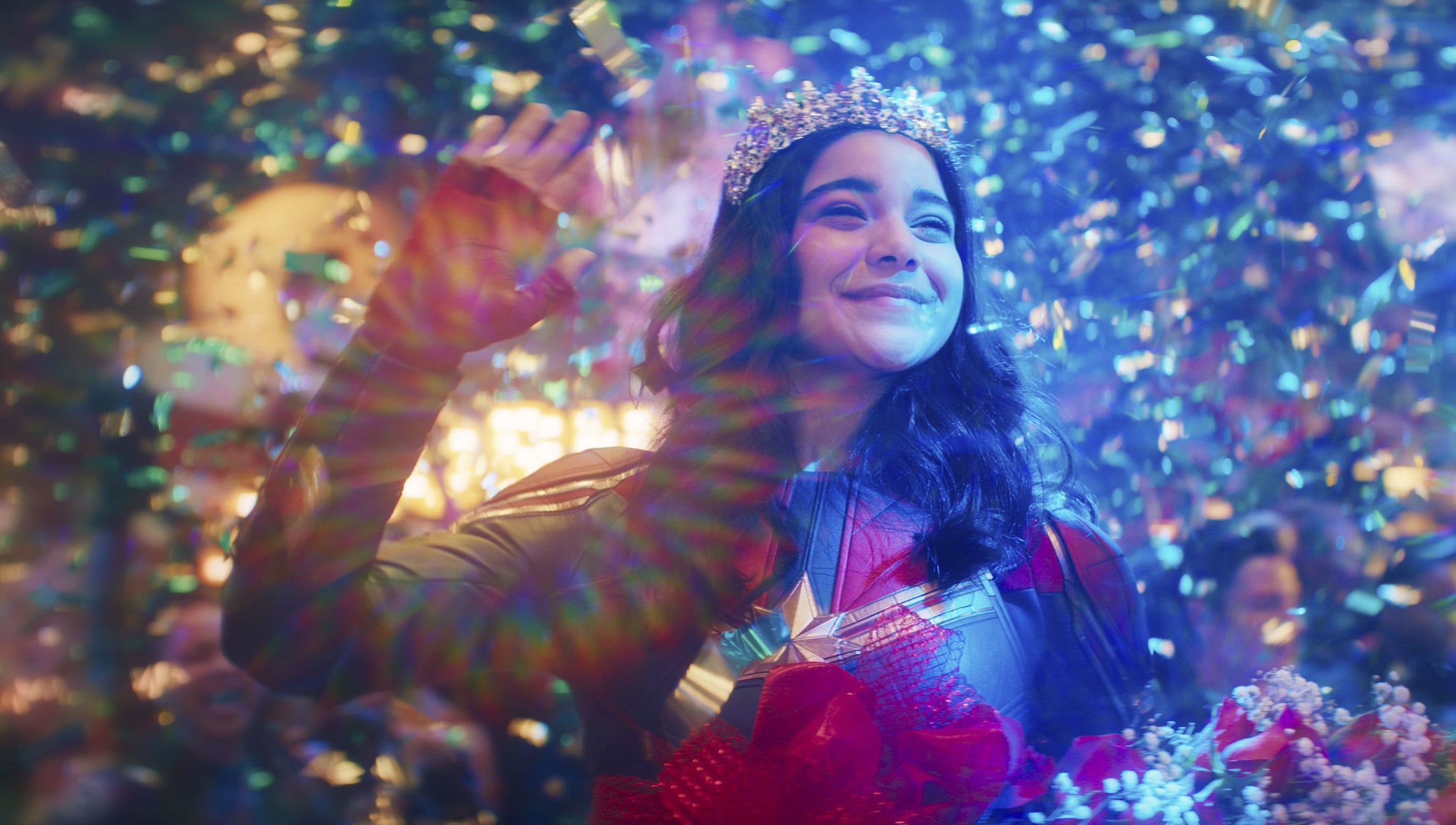 Iman Vellani dressed as Ms. Marvel wearing a crown
