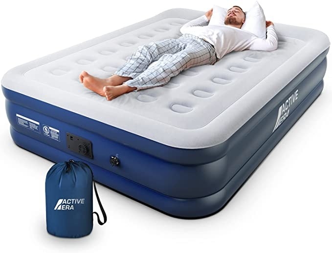 A person sleeping on the air mattress against a plain background