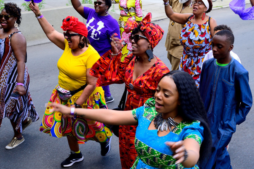 a group of Black people march in a juneteenth parade