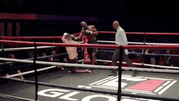 Idris knocking his opponent to the mat and the ref calling off the fight