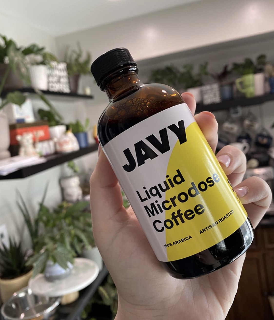 reviewer holding the coffee concentrate