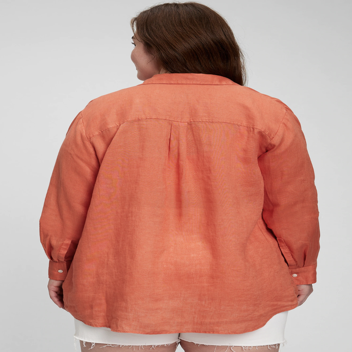 A person showing off the back of the top