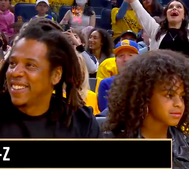 Jay-Z still grinning while Blue Ivy frustratedly looks the other direction