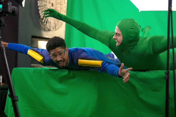 Keiynan Lonsdale and Dylan Sprouse horse around in front of a green screen