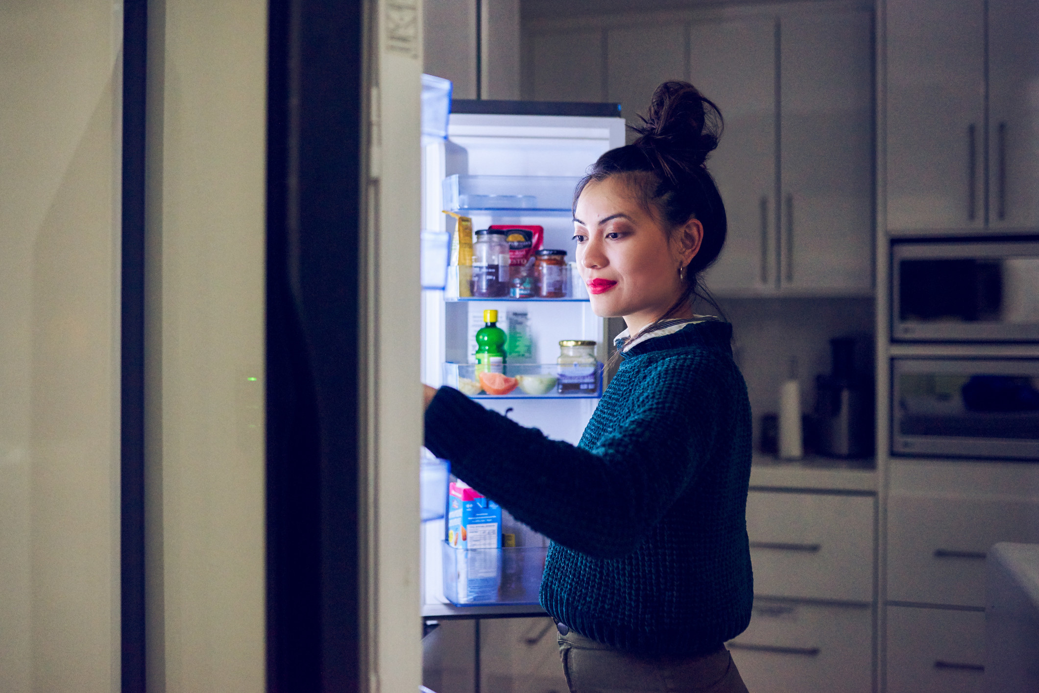 person looking through a fridge
