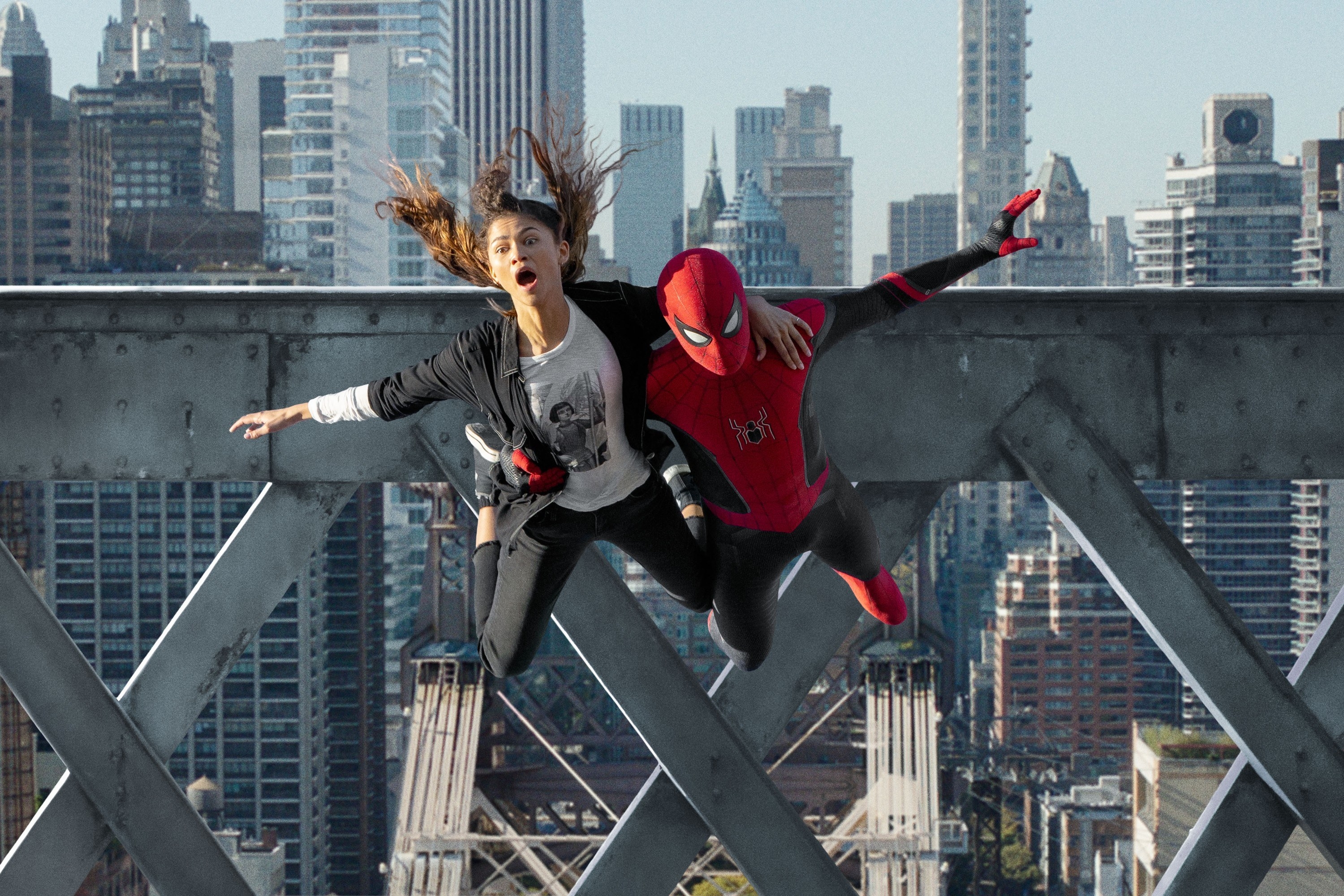 Spider-Man dives off of a bridge, holding a screaming M.J.