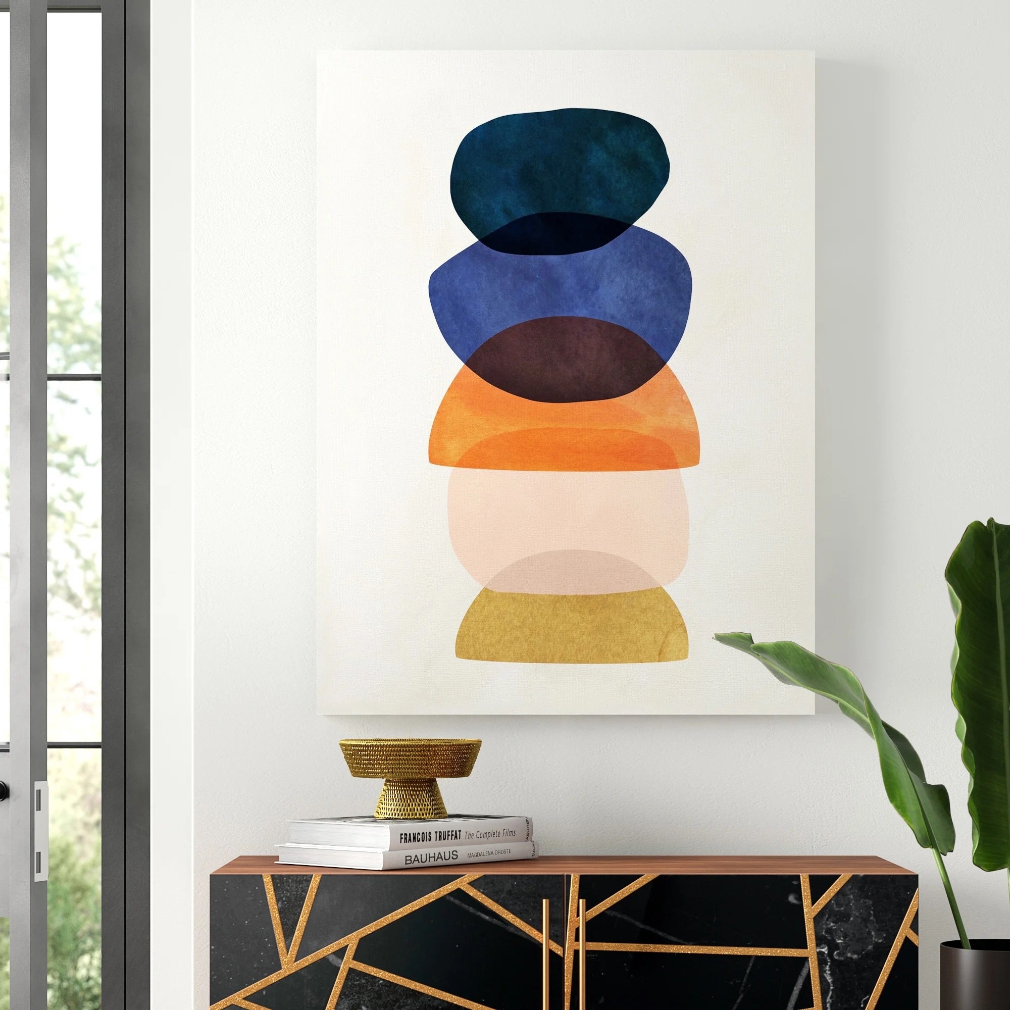 the colorful canvas print hanging above a side table