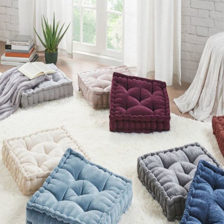 the floor pillows in various colors on the floor