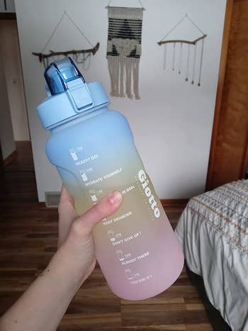 a reviewer holding the water bottle