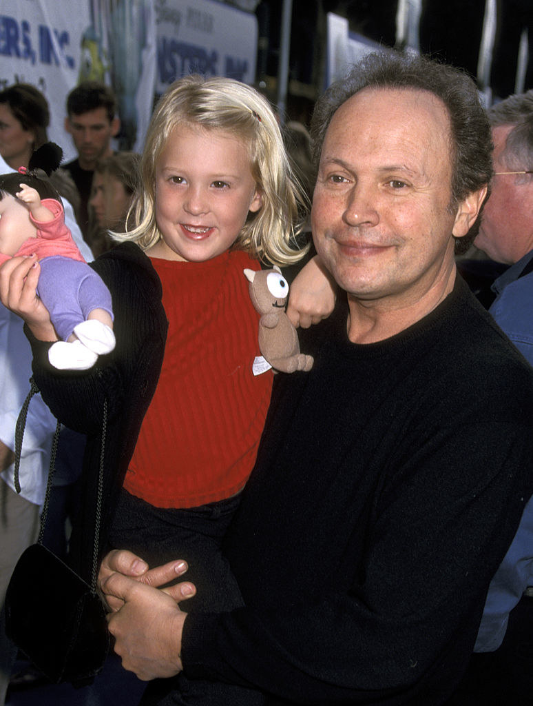 mary holding a toy while billy crystal carries her
