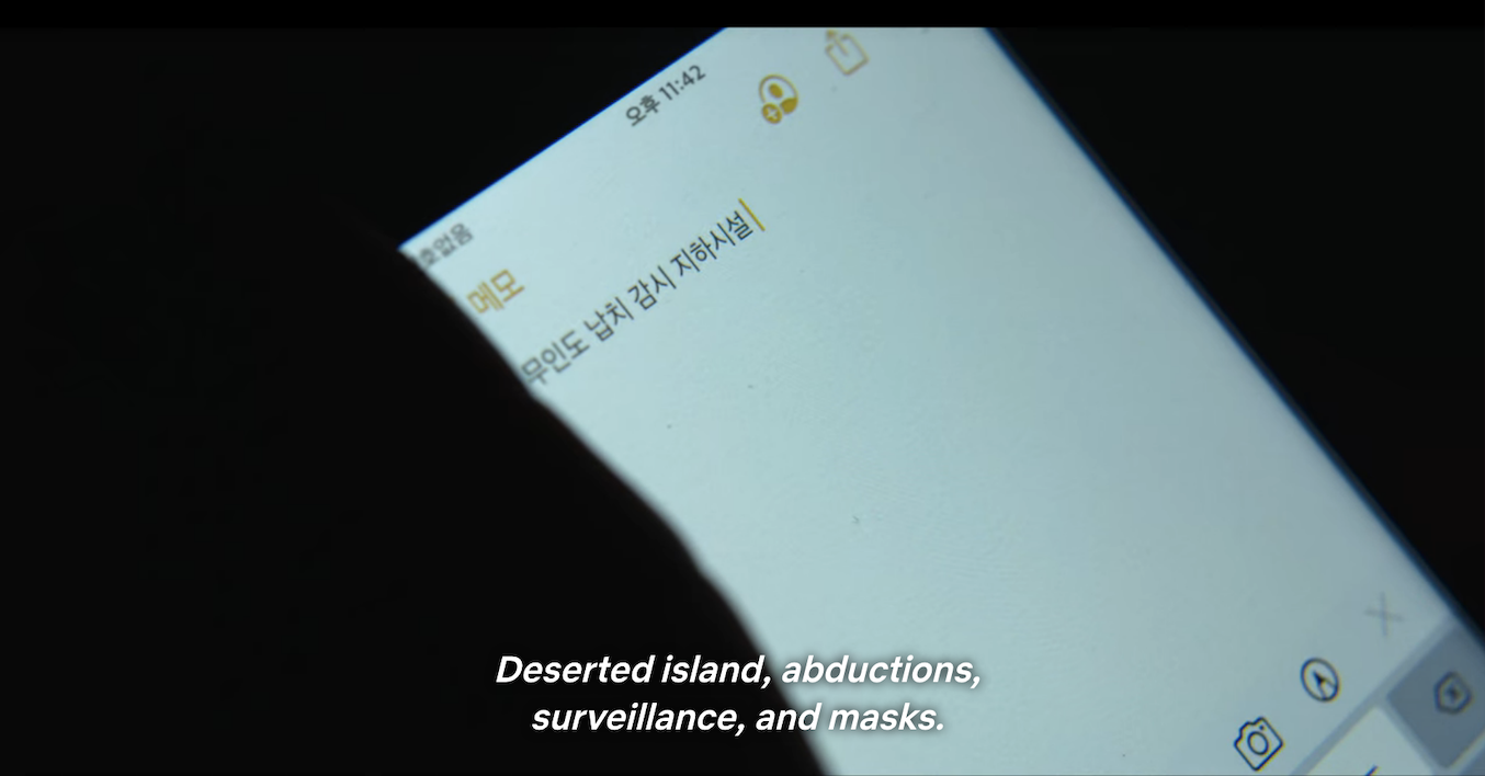 a phone with the words &quot;deserted island, abductions, surveillance, and masks&quot;
