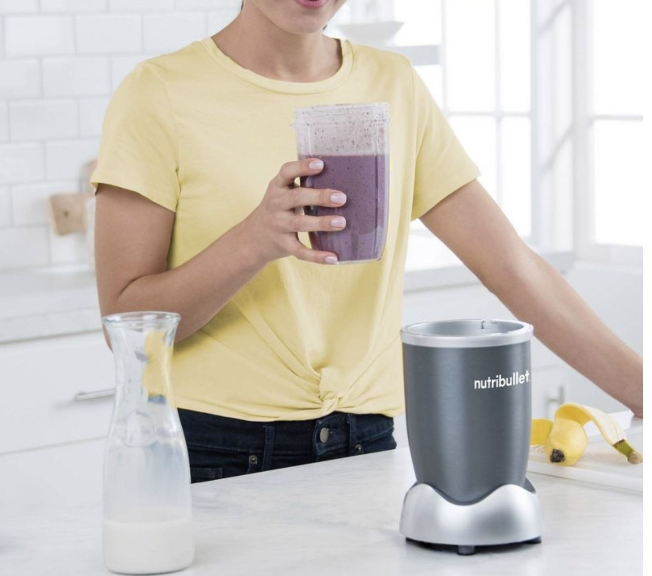 A model drinking a smoothie made with a single serve blender