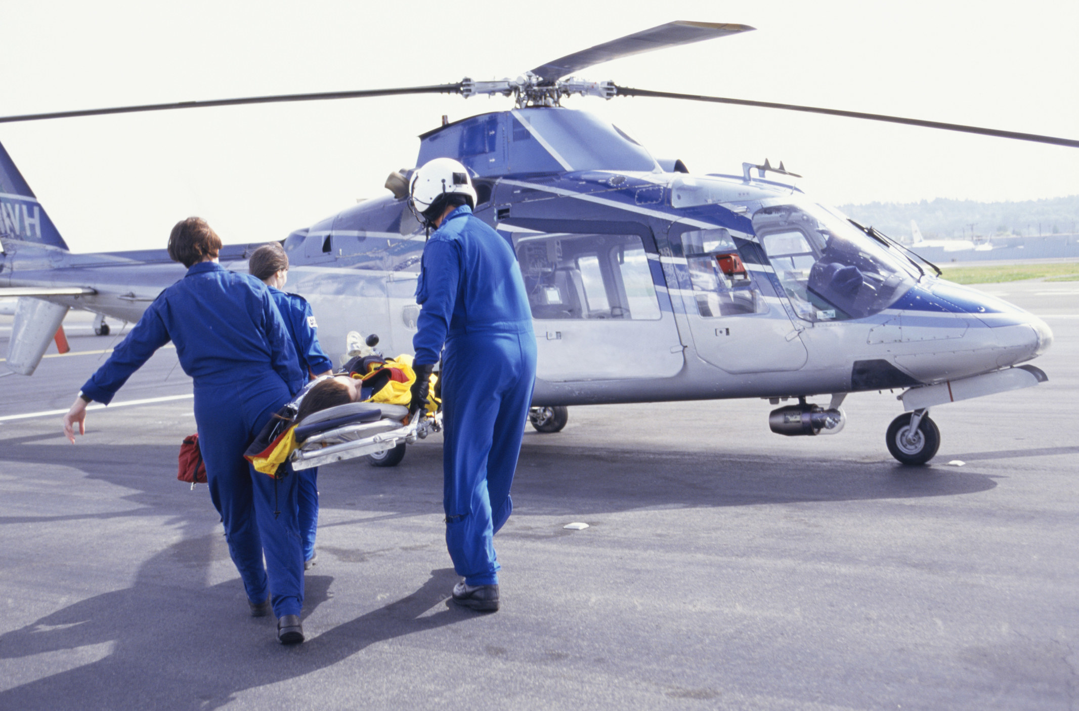 medical workers taking a patient to a helicopter