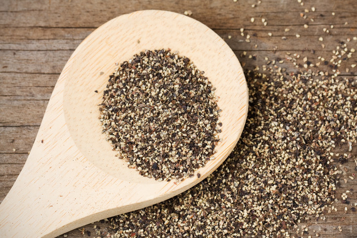 Ground pepper spread on a wooden surface
