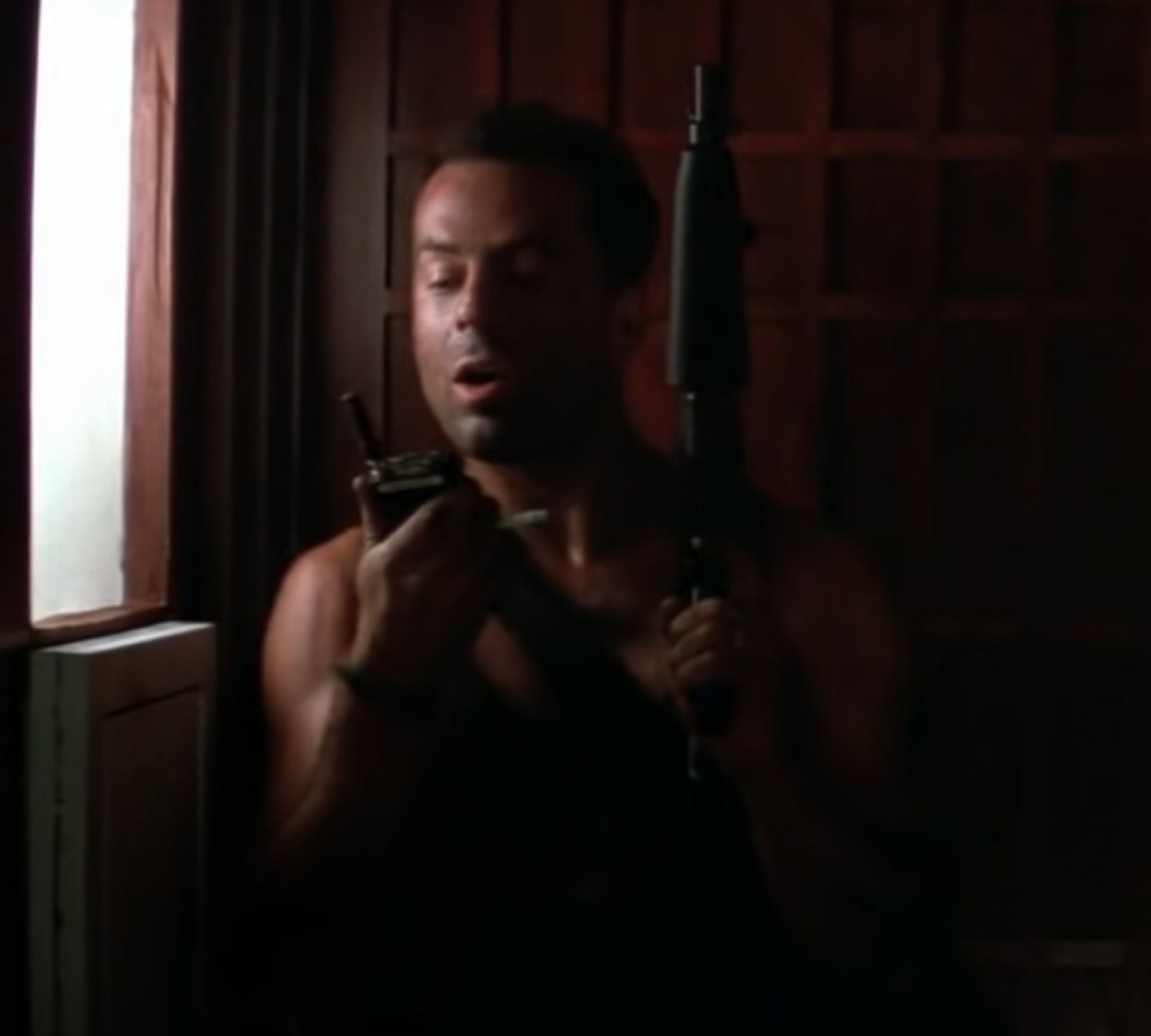 Bruce Willis as John McClane communicates with Hans via walkie-talkie in &quot;Die Hard&quot;