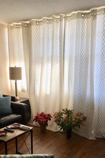 A customer review shows their window with new curtains