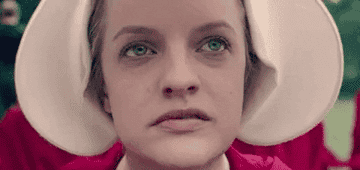 Close up of Elizabeth Moss&#x27; face as Offred/June in The Handmaid&#x27;s Tale