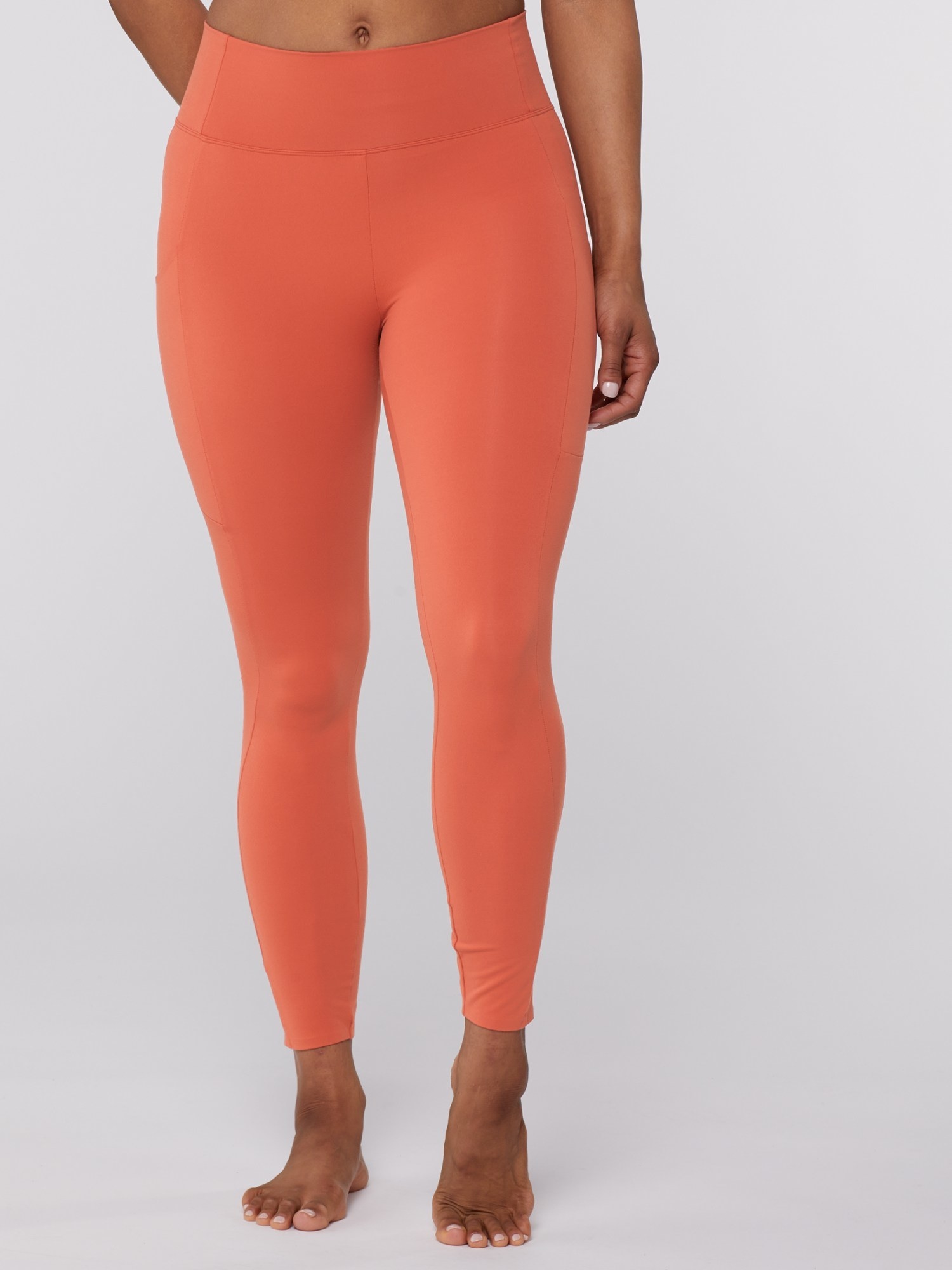 a model wearing the orange leggings