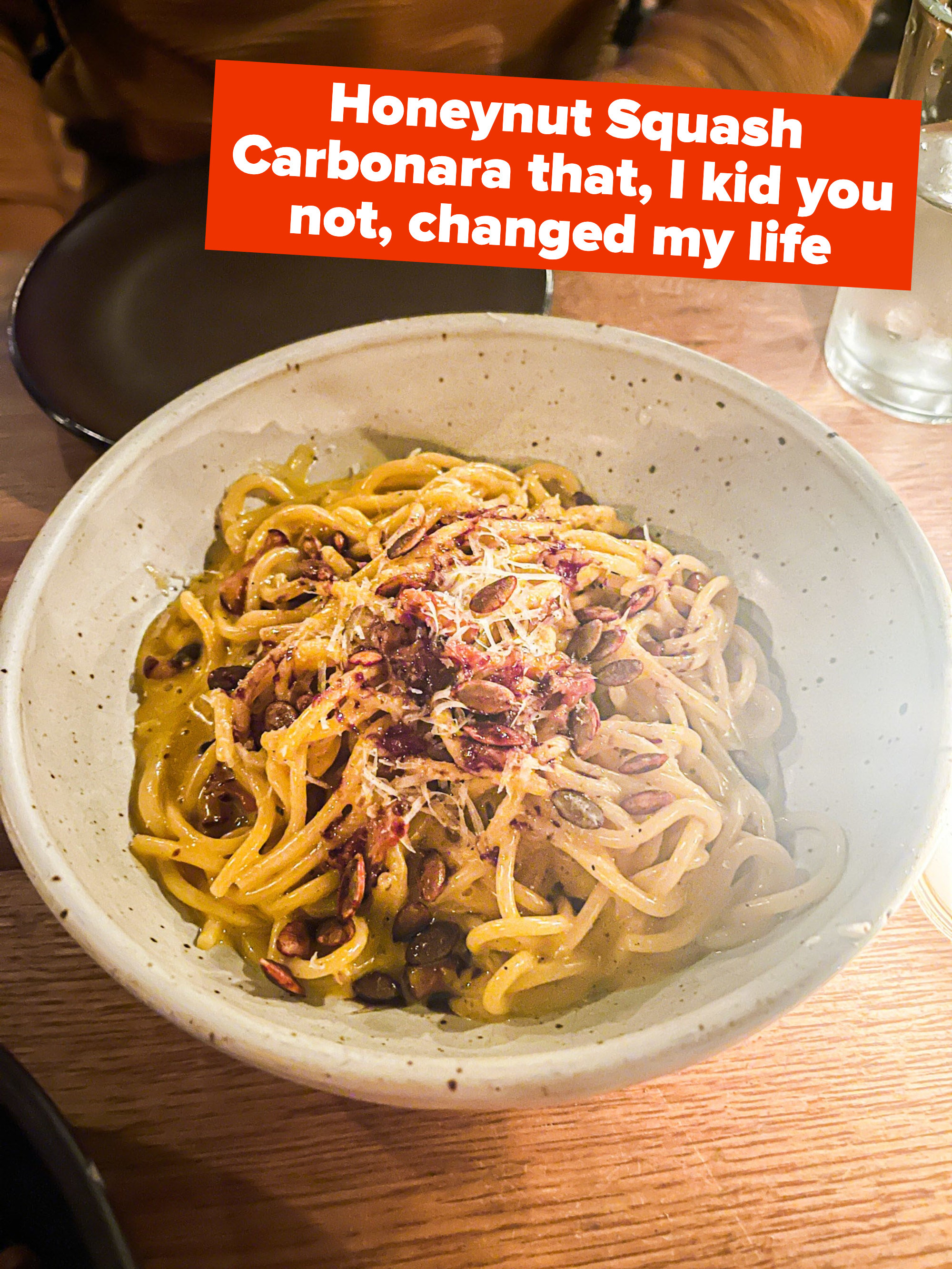 A bowl of carbonara with the text &quot;Honeynut Squash Carbonara that, I kid you not, changed my life&quot;